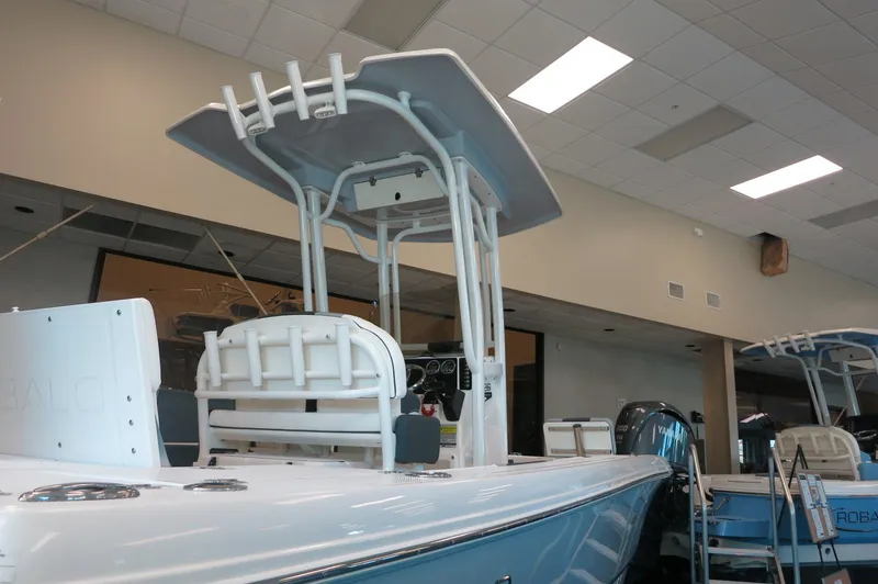 Slide: The Image of 2025 Robalo 226 Cayman boat displayed indoors, featuring a sleek design and modern equipment. - 4
