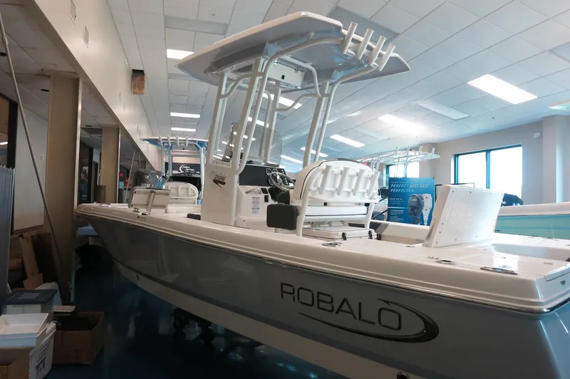 Slide: The Image of 2025 Robalo 226 Cayman boat displayed indoors with sleek design and modern features. - 6