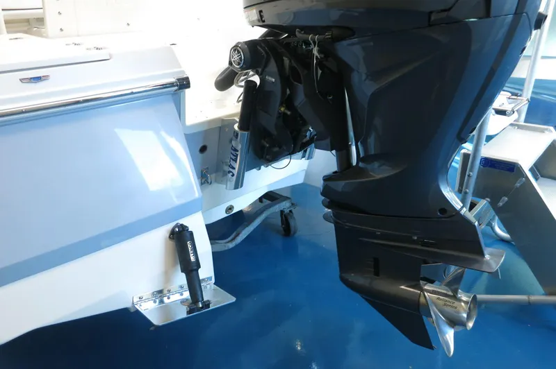Slide: The Image of 2025 Robalo 226 Cayman boat with Yamaha outboard motor, displayed indoors. - 8