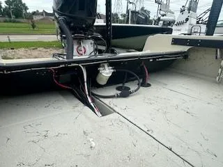 Slide: The Image of 1976 Boston Whaler 21 Outrage boat interior with visible engine and wiring. - 10