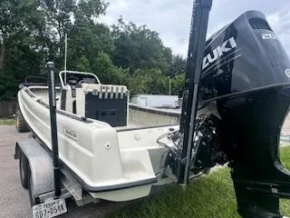 Slide: The Image of 1976 Boston Whaler 21 Outrage boat on trailer with Suzuki outboard motor. - 14