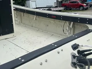 Slide: The Image of 1976 Boston Whaler 21 Outrage boat interior with visible seating and railing. - 16