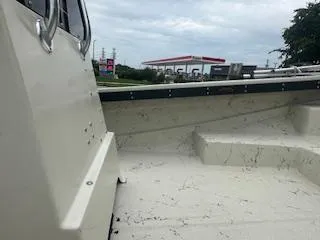 Slide: The Image of 1976 Boston Whaler 21 Outrage boat interior with gas station in background. - 18