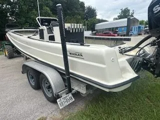 Slide: The Image of 1976 Boston Whaler 21 Outrage boat on trailer, parked outdoors. - 2