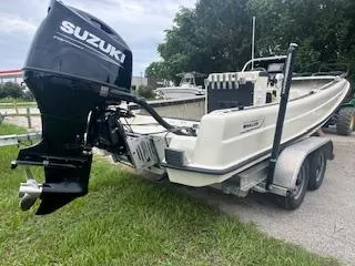 Slide: The Image of 1976 Boston Whaler 21 Outrage boat on trailer with Suzuki outboard motor. - 4