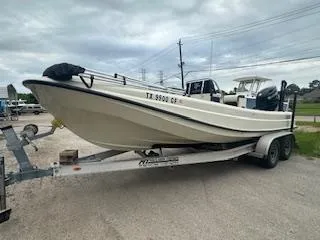 Slide: The Image of 1976 Boston Whaler 21 Outrage on trailer, parked outdoors, overcast sky. - 6