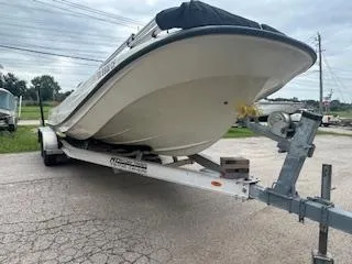 Slide: The Image of 1976 Boston Whaler 21 Outrage boat on trailer, parked outdoors. - 7