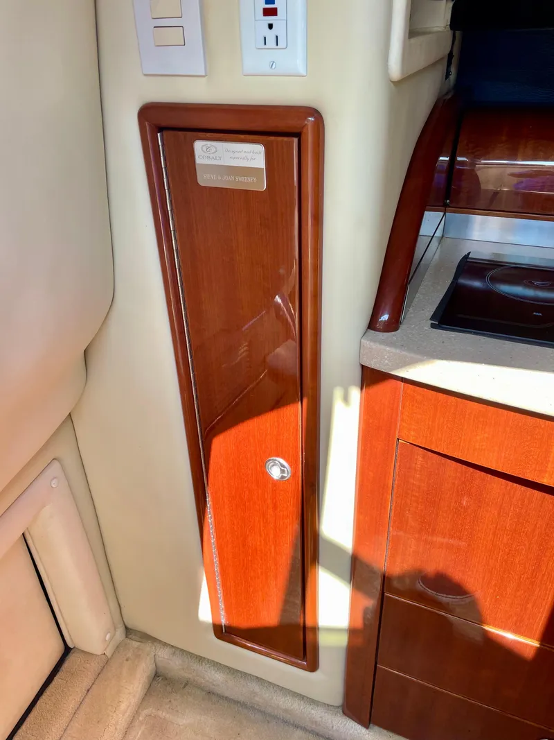 Slide: The Image of 2006 Cobalt 323 interior with wooden cabinetry and electrical panel. - 13