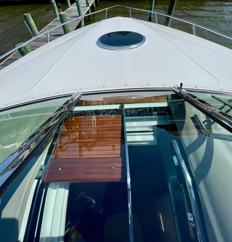 Slide: The Image of Bow view of a 2006 Cobalt 323 boat docked by wooden piers. - 17