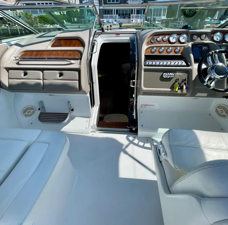 Slide: The Image of Interior of a 2006 Cobalt 323 boat with dashboard and seating area. - 19