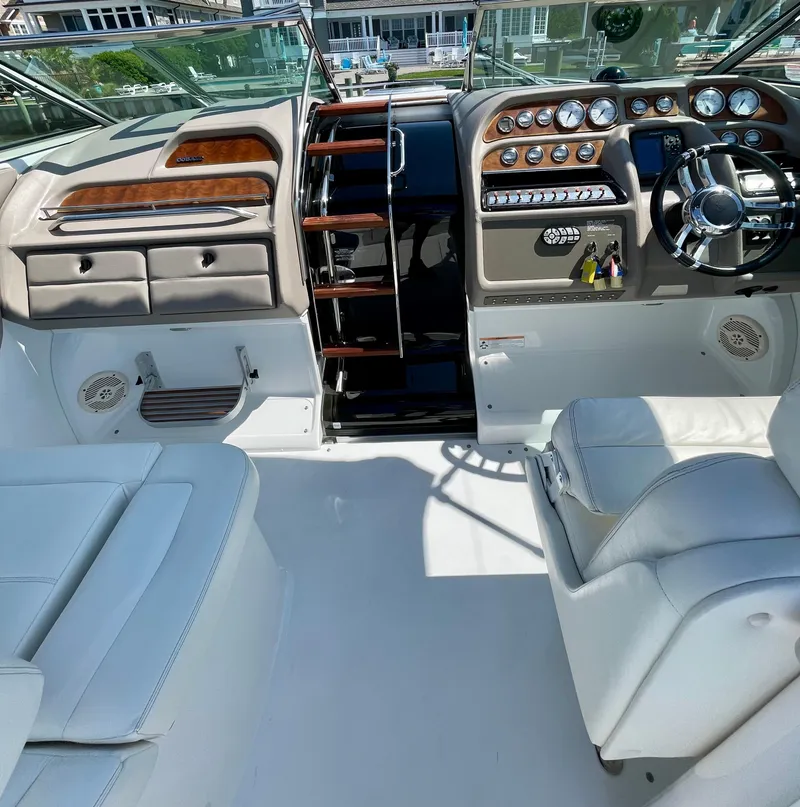 Slide: The Image of Interior of a 2006 Cobalt 323 boat with luxurious seating and control panel. - 21
