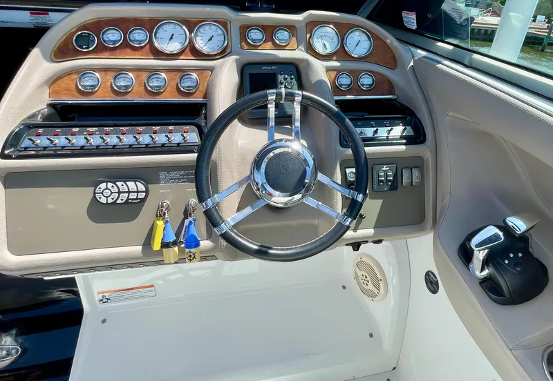 Slide: The Image of Dashboard of a 2006 Cobalt 323 boat with steering wheel and control panel. - 24