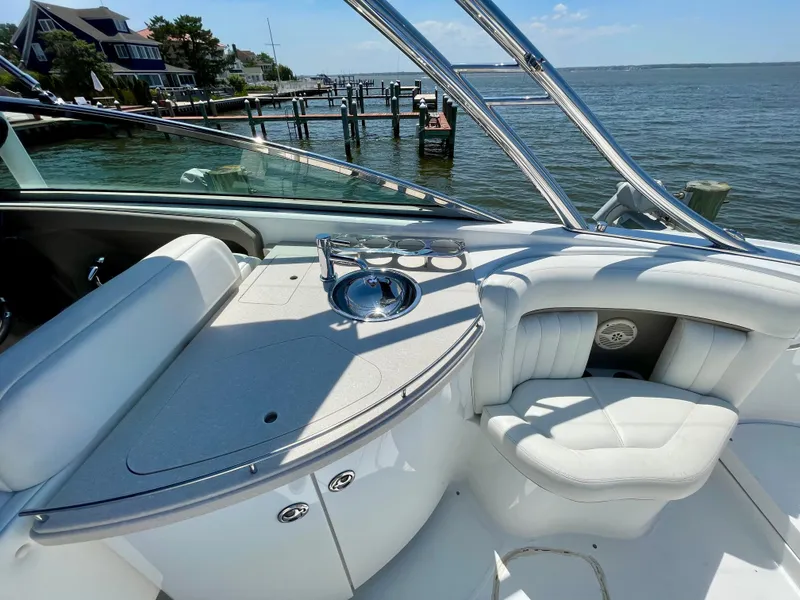Slide: The Image of Luxury interior of 2006 Cobalt 323 boat with seating and sink, docked by waterfront homes. - 28