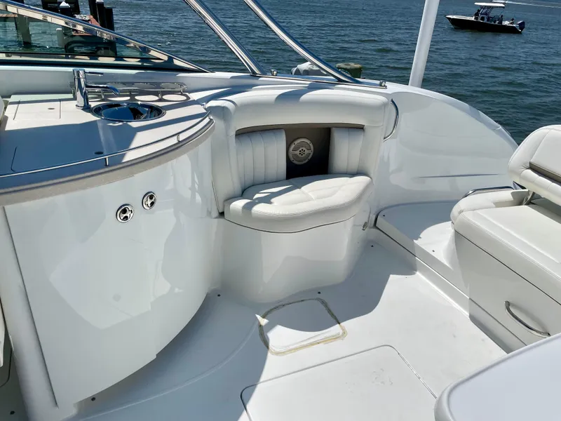 Slide: The Image of 2006 Cobalt 323 boat interior with white seating and sleek design on the water. - 29