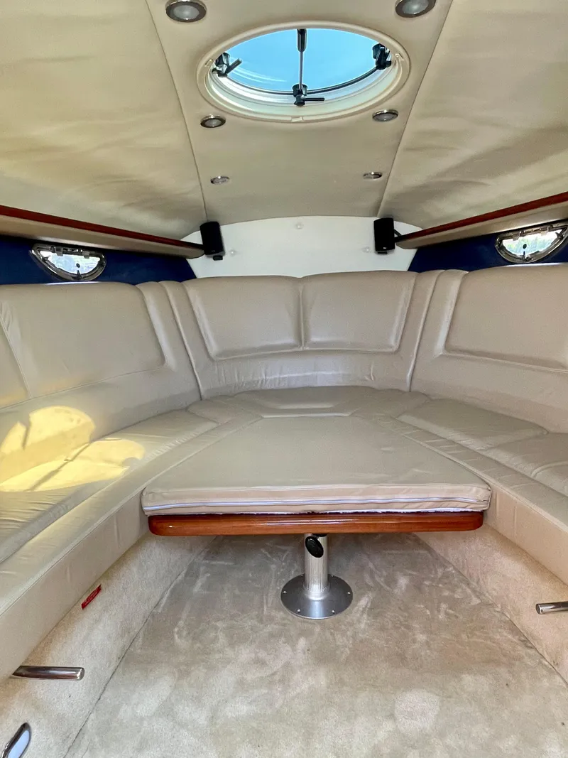 Slide: The Image of Luxurious interior of a 2006 Cobalt 323 boat with beige seating and overhead skylight. - 3