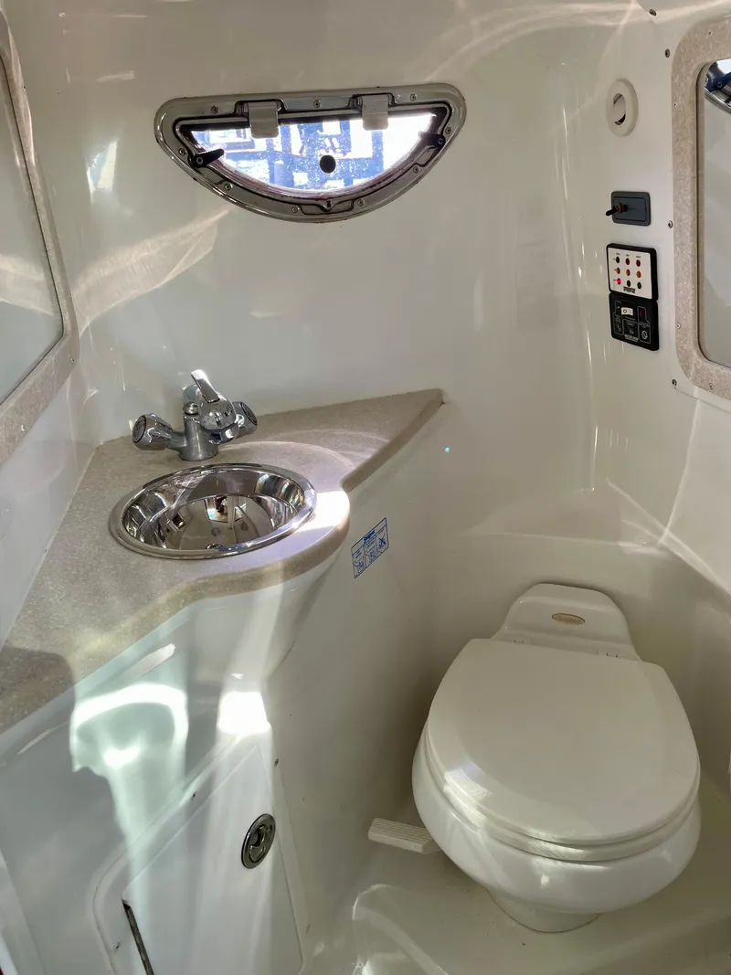 Slide: The Image of Compact bathroom in 2006 Cobalt 323 boat with sink, toilet, and window. - 30