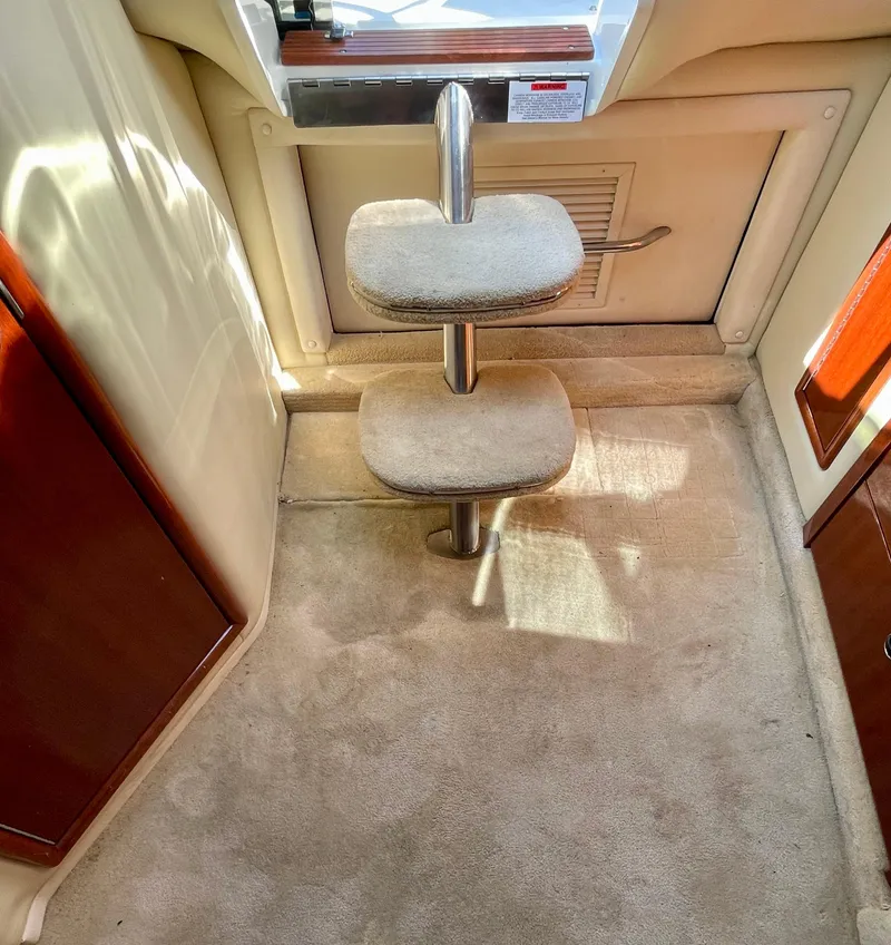 Slide: The Image of Interior of a 2006 Cobalt 323 boat with carpeted steps and wooden accents. - 4