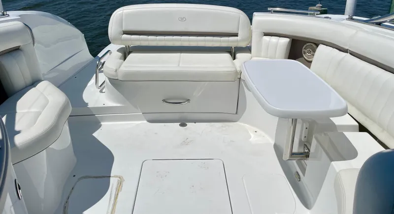 Slide: The Image of Luxurious seating area on a 2006 Cobalt 323 boat with white upholstery and table. - 7