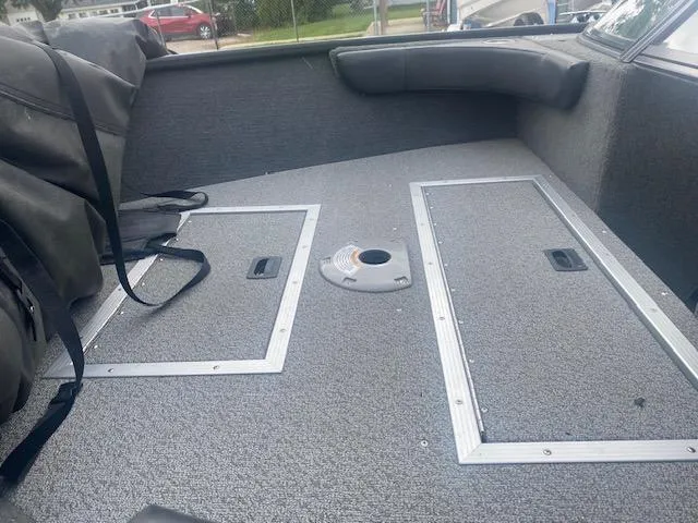 Slide: The Image of Interior of a 2019 Starweld Fusion Pro 18 DC boat, featuring storage compartments. - 11