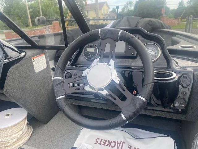 Slide: The Image of Steering wheel of a 2019 Starweld Fusion Pro 18 DC boat, featuring modern controls and dashboard. - 6