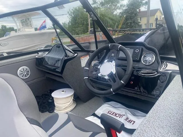 Slide: The Image of Interior of a 2019 Starweld Fusion Pro 18 DC boat with steering wheel and life jackets. - 7