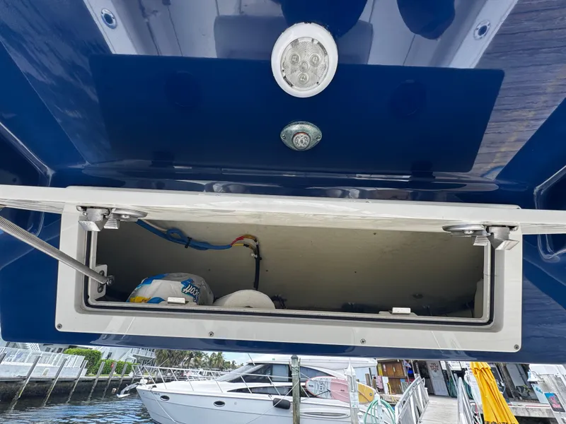 Slide: The Image of Open storage compartment on a 2015 Cobia 237 Center Console boat. - 13