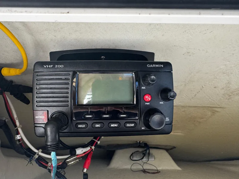 Slide: The Image of Garmin VHF 200 radio on 2015 Cobia 237 Center Console boat dashboard. - 14