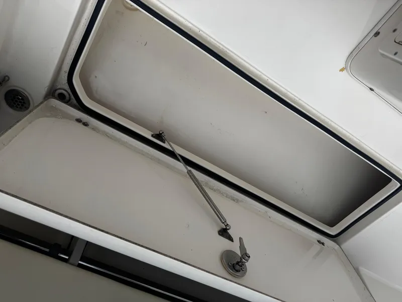Slide: The Image of Open storage compartment on 2015 Cobia 237 Center Console boat. - 20