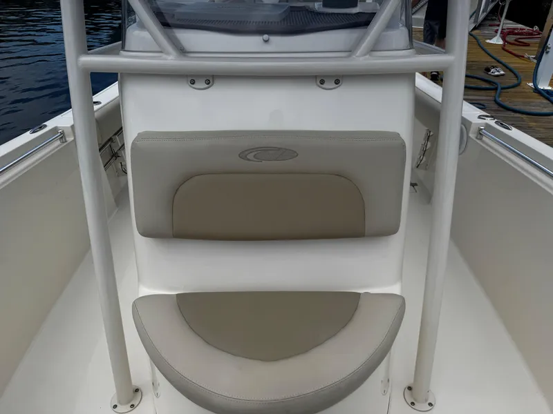 Slide: The Image of 2015 Cobia 237 Center Console boat seating area with beige cushions. - 21