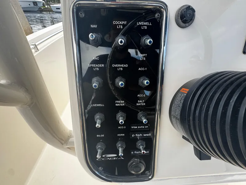 Slide: The Image of Control panel of a 2015 Cobia 237 Center Console boat with labeled switches. - 29