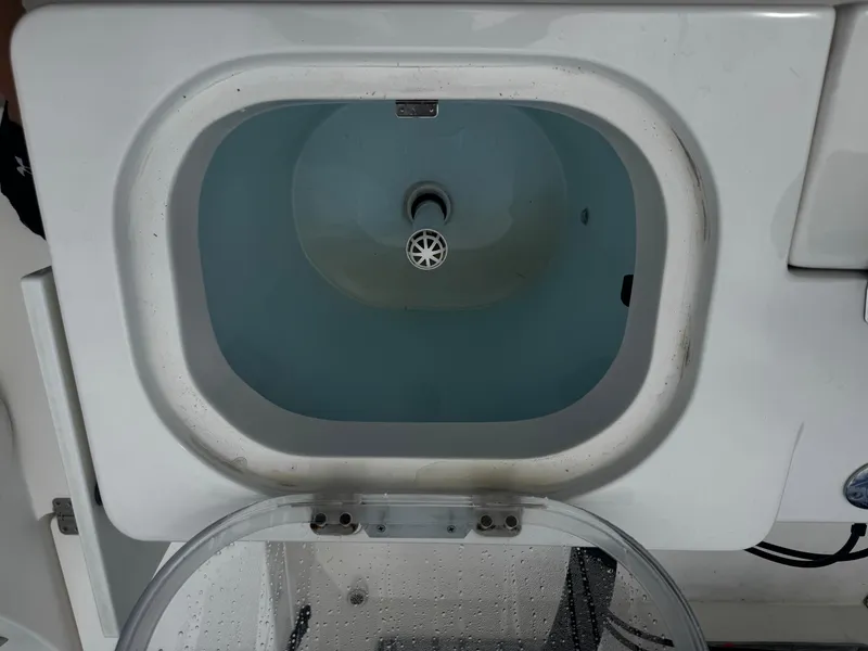 Slide: The Image of Livewell on a 2015 Cobia 237 Center Console boat, filled with water. - 33