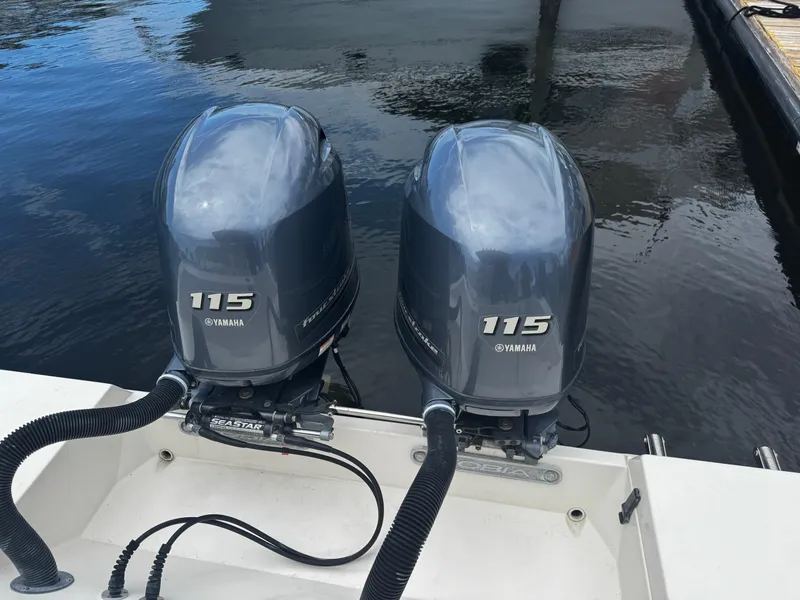 Slide: The Image of Twin Yamaha 115 outboard motors on a 2015 Cobia 237 Center Console boat. - 34