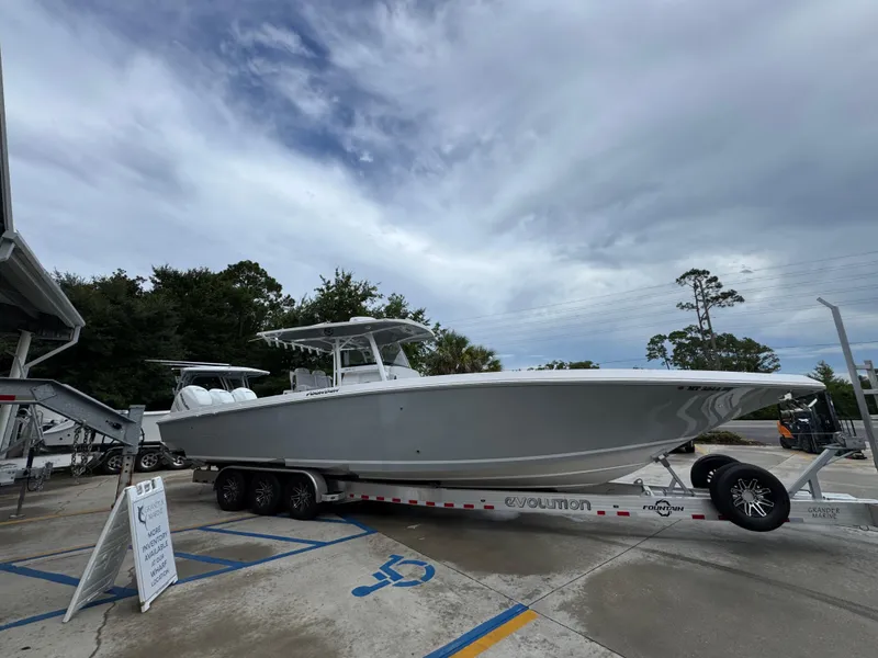 Slide: The Image of 2022 Fountain 38 CC boat on trailer under cloudy sky. - 10