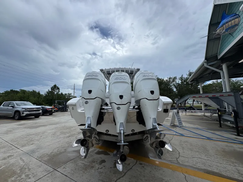 Slide: The Image of 2022 Fountain 38 CC boat with four powerful outboard engines in a parking area. - 14