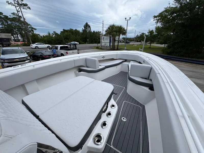 Slide: The Image of 2022 Fountain 38 CC boat interior with white seating and gray flooring. - 18