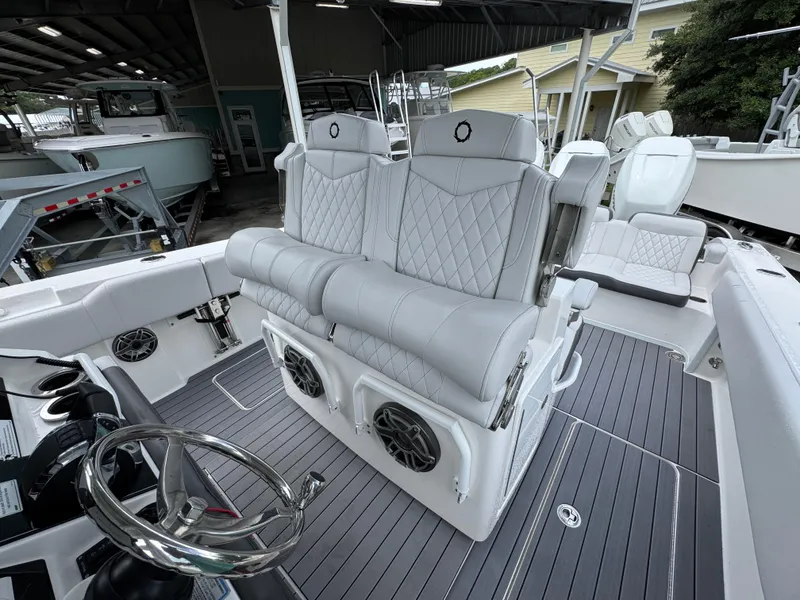 Slide: The Image of 2022 Fountain 38 CC boat interior with luxurious seating and modern steering wheel. - 28
