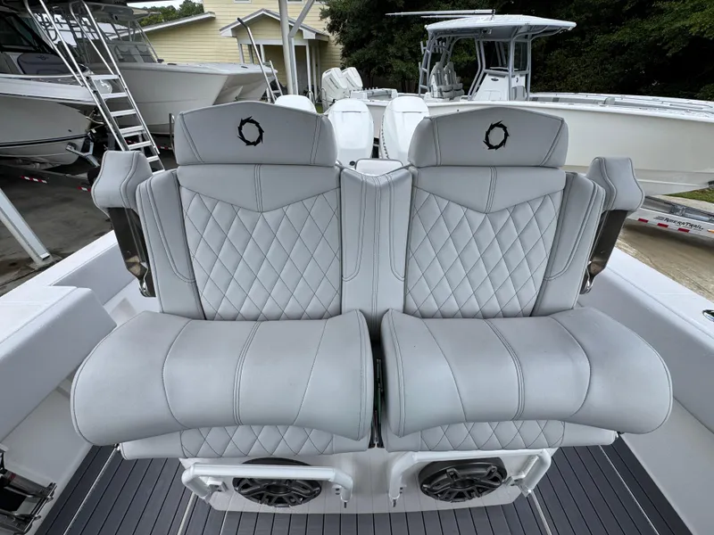 Slide: The Image of Luxury seating on a 2022 Fountain 38 CC boat, featuring diamond-stitched upholstery. - 29