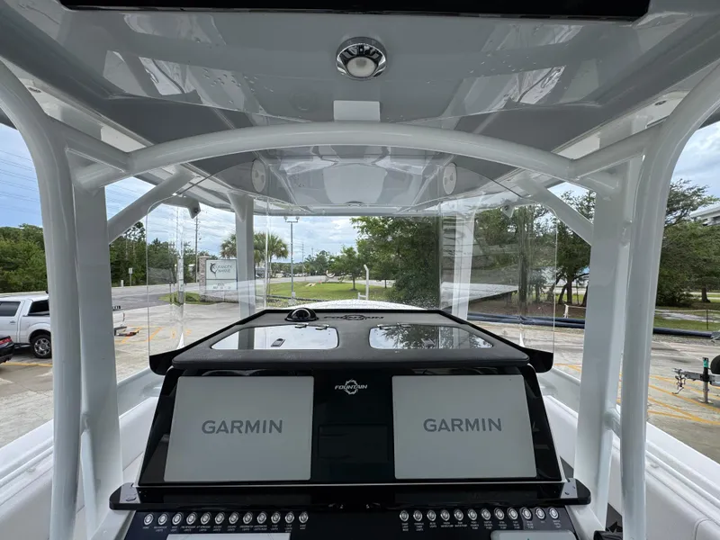 Slide: The Image of 2022 Fountain 38 CC boat dashboard with dual Garmin displays and control panel. - 33
