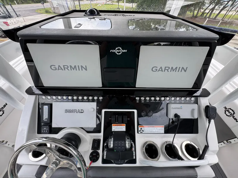 Slide: The Image of Control panel of 2022 Fountain 38 CC boat with Garmin and Simrad displays. - 34