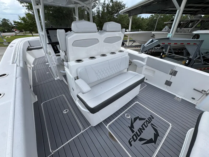 Slide: The Image of 2022 Fountain 38 CC boat interior with white seating and gray flooring. - 35