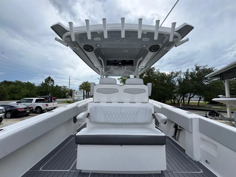 Slide: The Image of 2022 Fountain 38 CC boat interior with seating and overhead rod holders. - 36