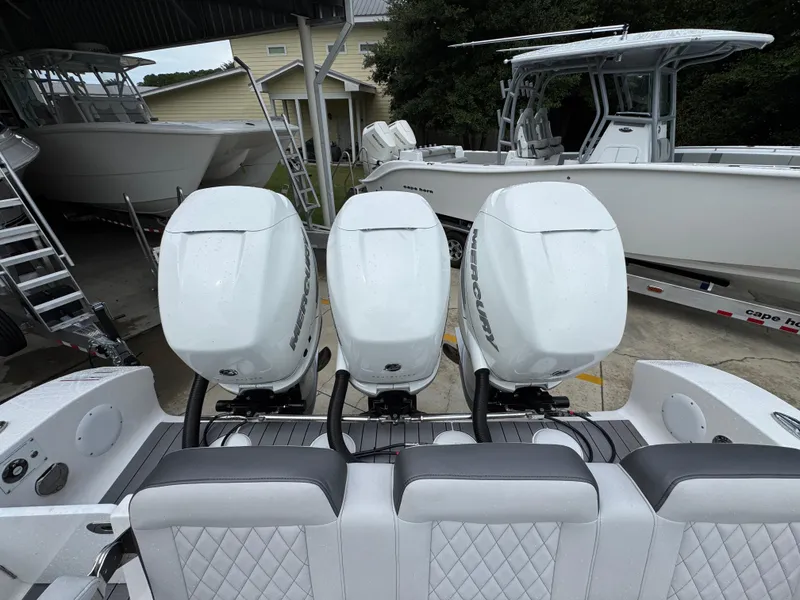 Slide: The Image of 2022 Fountain 38 CC boat with triple Mercury outboard engines in a covered storage area. - 40
