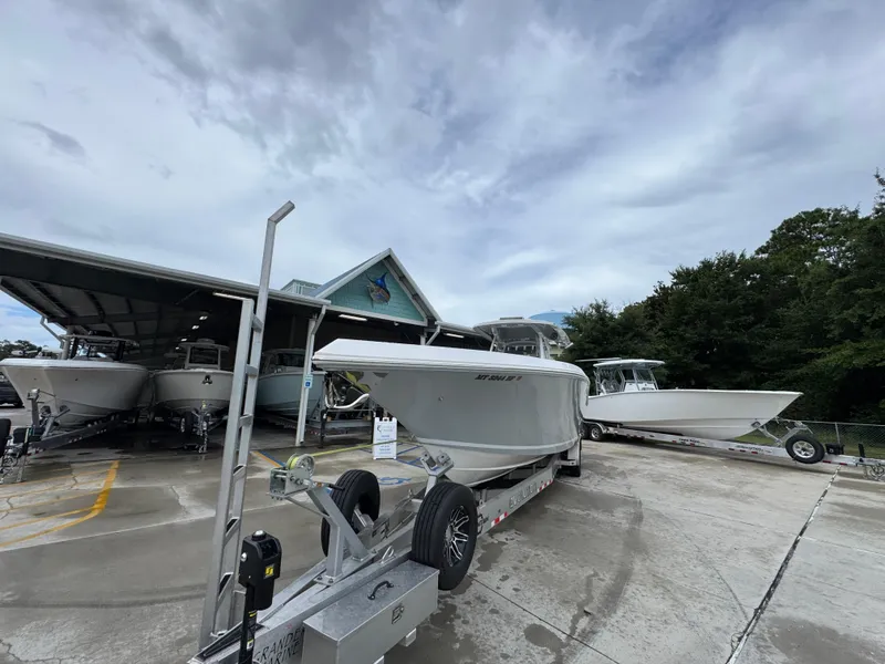 Slide: The Image of 2022 Fountain 38 CC boat on trailer at marina, cloudy sky background. - 5