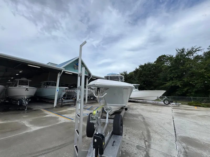 Slide: The Image of 2022 Fountain 38 CC boat on trailer, parked outside a storage facility. - 6