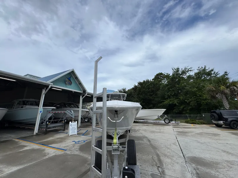 Slide: The Image of 2022 Fountain 38 CC boat on trailer at marina under cloudy sky. - 7