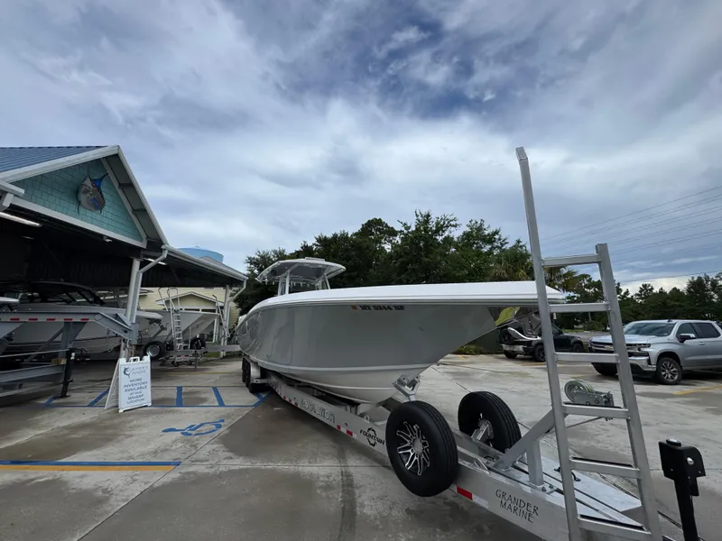 Slide: The Image of 2022 Fountain 38 CC boat on trailer at marina under cloudy sky. - 8
