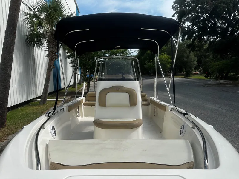 Slide: The Image of 2019 Key West 189FS boat with canopy, parked near palm trees. - 7