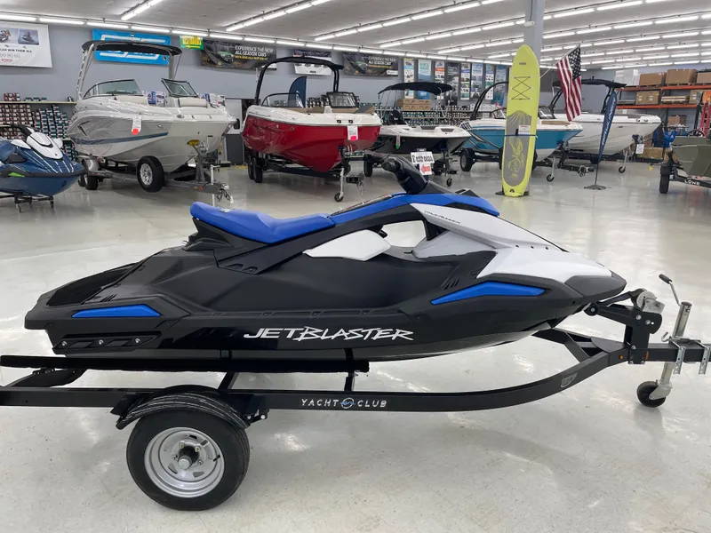 Slide: The Image of 2025 Yamaha WaveRunner JetBlaster on trailer in showroom with boats and accessories. - 4