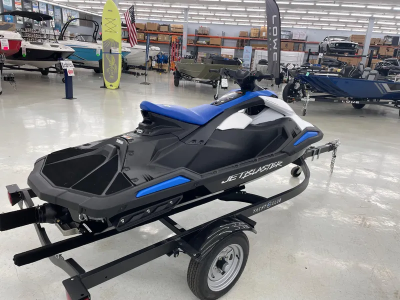 Slide: The Image of 2025 Yamaha WaveRunner JetBlaster on trailer in showroom, surrounded by boats and equipment. - 5