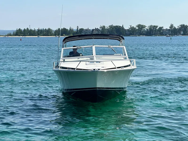 Slide: The Image of 1988 Bertram 28 Moppie boat cruising on clear blue water. - 2